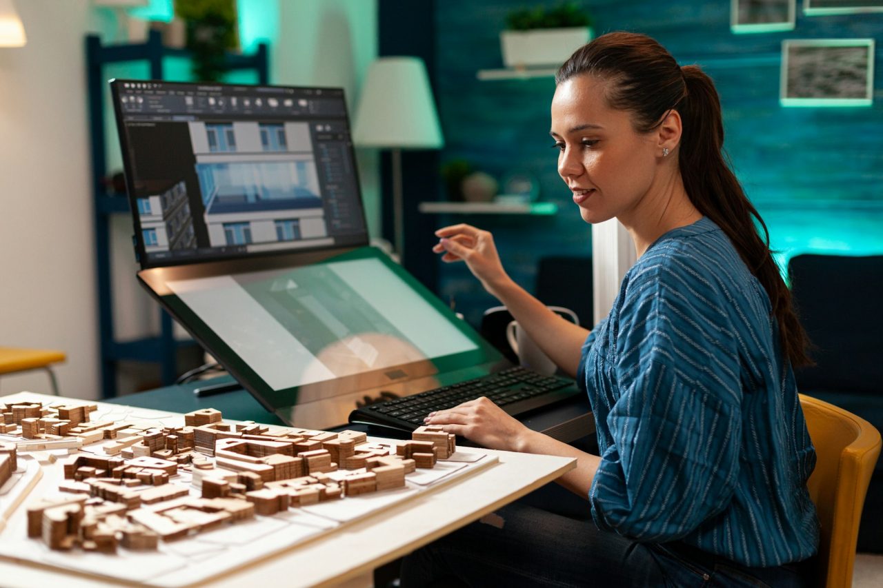 young-architect-working-on-building-miniature-maquette.jpg